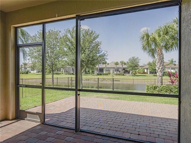4348 Beauty Leaf Cir, Vero Beach, FL 32967 - doorway with a residential view, a water view, and brick floor