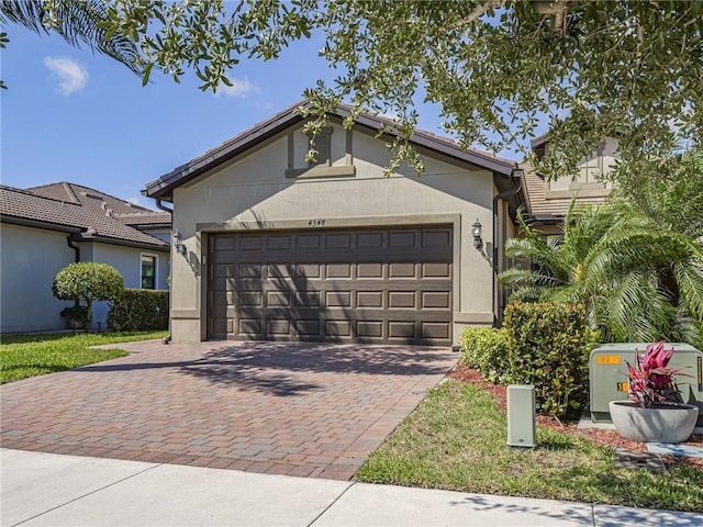 4348 Beauty Leaf Cir, Vero Beach, FL 32967 - ranch-style home with decorative driveway, an attached garage, and stucco siding