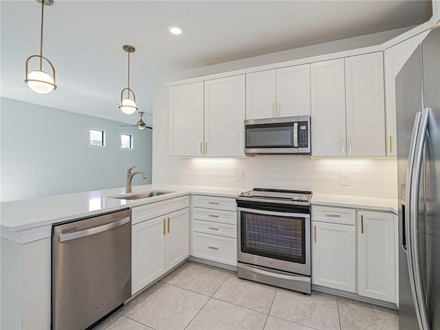 4348 Beauty Leaf Cir, Vero Beach, FL 32967 - kitchen featuring a sink, appliances with stainless steel finishes, light countertops, light tile patterned flooring, and a peninsula