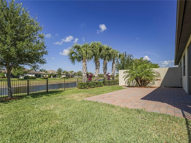 4348 Beauty Leaf Cir, Vero Beach, FL 32967 - view of yard with a fenced backyard, a water view, and a patio area