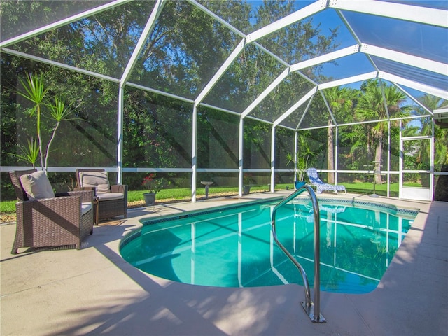 view of swimming pool featuring a lanai and a patio area