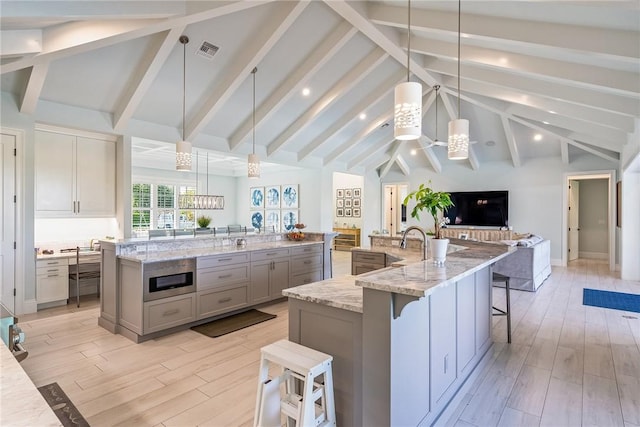 951 W Polo Grounds Dr, Vero Beach, FL 32966 - kitchen featuring a spacious island, open floor plan, light wood-style floors, and gray cabinetry
