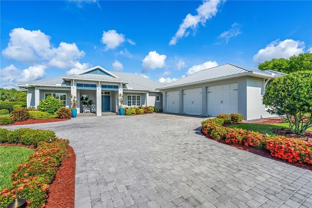 951 W Polo Grounds Dr, Vero Beach, FL 32966 - ranch-style house with decorative driveway, stucco siding, a standing seam roof, a metal roof, and covered porch