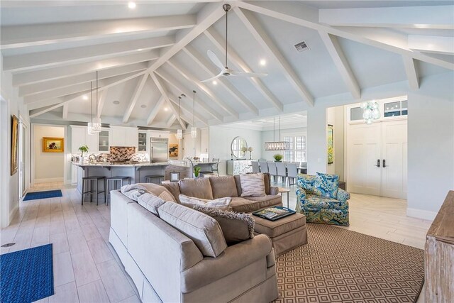 951 W Polo Grounds Dr, Vero Beach, FL 32966 - living room with beamed ceiling, ceiling fan, high vaulted ceiling, and light wood-type flooring
