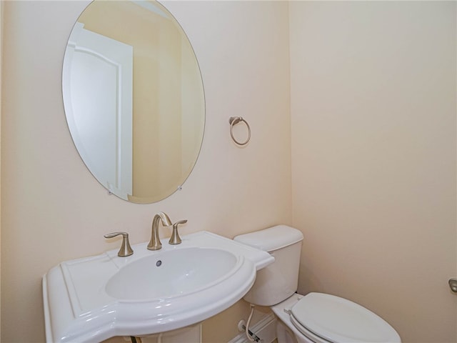 bathroom with toilet and sink