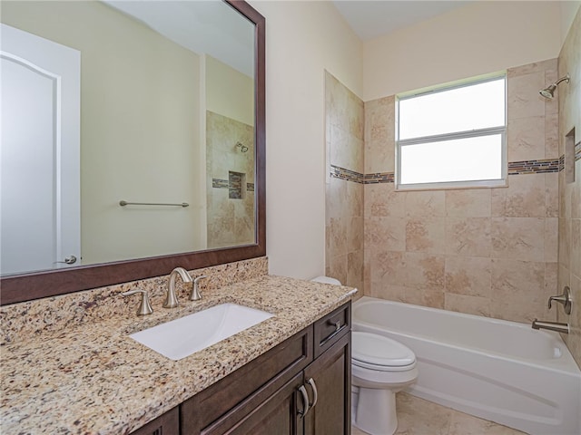 full bathroom with tiled shower / bath, tile patterned floors, toilet, and vanity