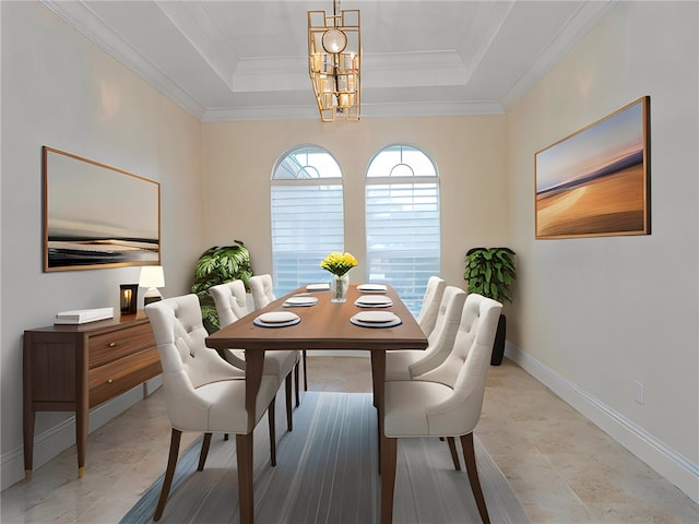 dining space featuring ornamental molding, a chandelier, and a tray ceiling