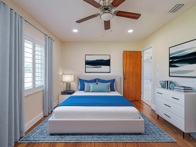 bedroom with ceiling fan and hardwood / wood-style floors