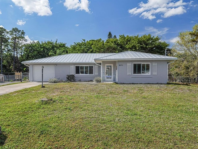 single story home featuring a garage and a front yard