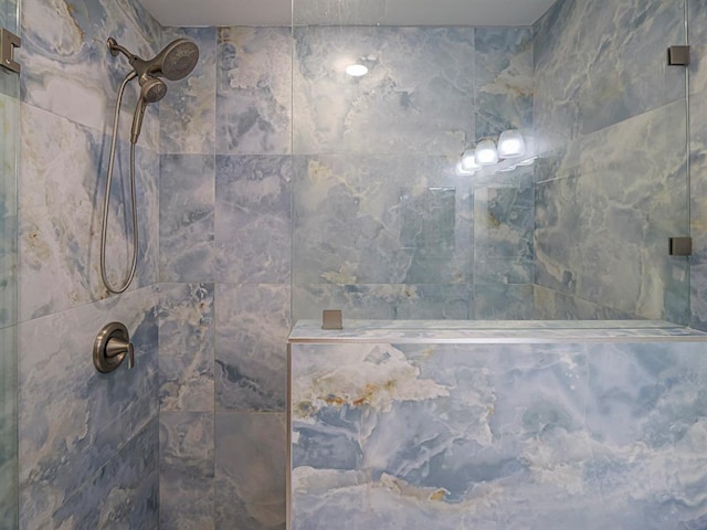 interior details featuring tiled shower