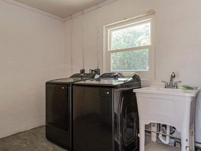 laundry area featuring separate washer and dryer and sink