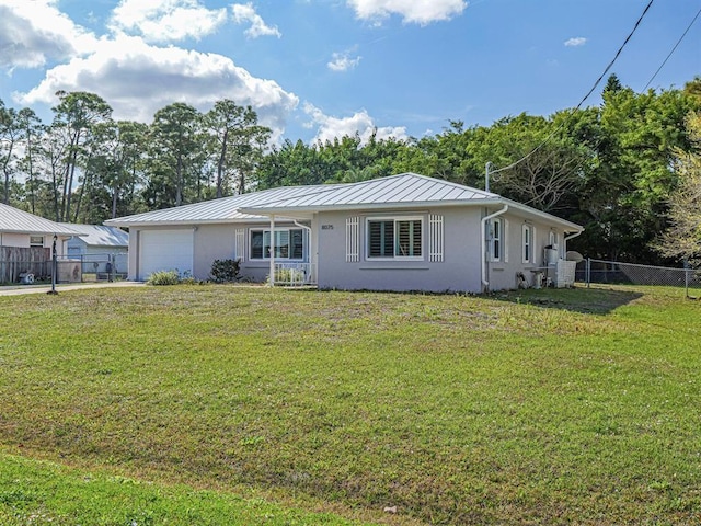 ranch-style home featuring a garage and a front lawn