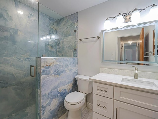 bathroom featuring vanity, an enclosed shower, and toilet