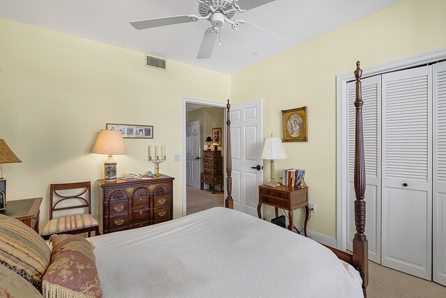 carpeted bedroom with ceiling fan and a closet