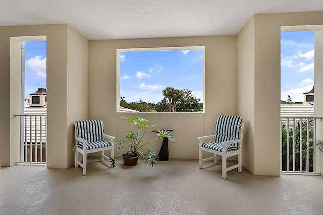 living area featuring a wealth of natural light and a textured ceiling