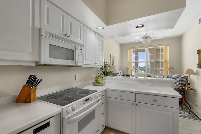 kitchen featuring white cabinets, kitchen peninsula, light tile patterned flooring, ceiling fan, and white appliances