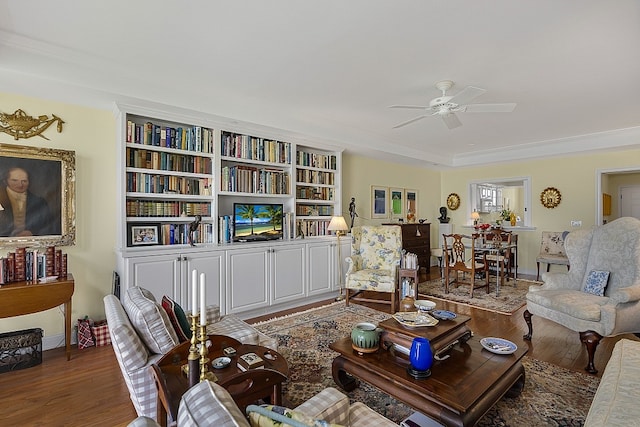 living room with crown molding, hardwood / wood-style flooring, and ceiling fan