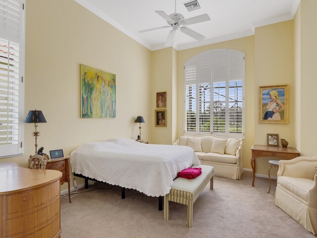 carpeted bedroom with ornamental molding and ceiling fan