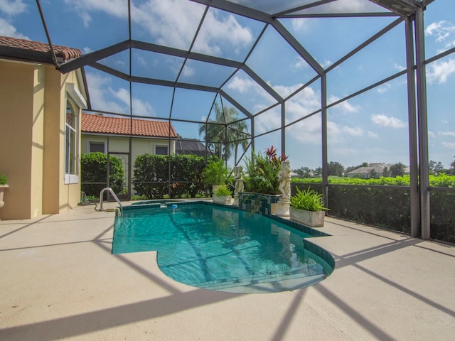 view of swimming pool with a patio area and a lanai