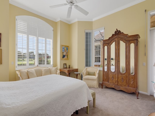 bedroom featuring ceiling fan, crown molding, and carpet floors