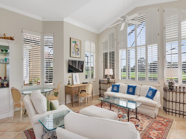 tiled living room featuring ornamental molding, lofted ceiling, a healthy amount of sunlight, and ceiling fan