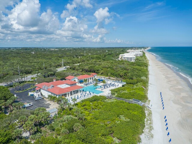 birds eye view of property featuring a beach view and a water view