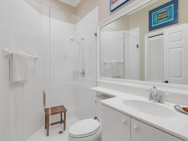 bathroom featuring toilet, vanity, and walk in shower