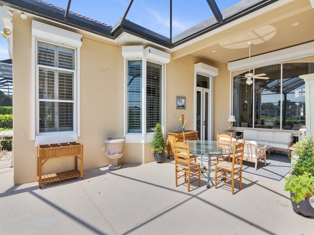 view of patio / terrace with a wall unit AC and ceiling fan