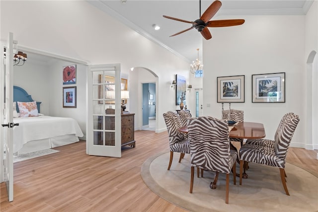 dining area featuring crown molding, ceiling fan, high vaulted ceiling, and light hardwood / wood-style floors