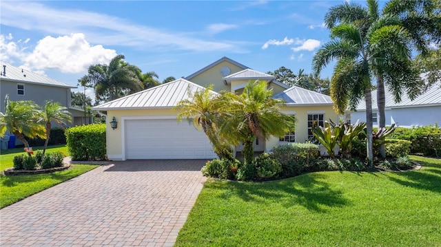 view of front facade with a garage and a front yard