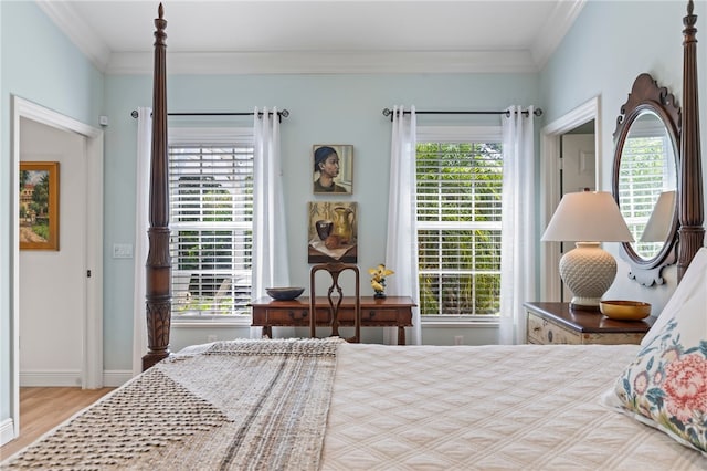 bedroom with ornamental molding and light hardwood / wood-style floors