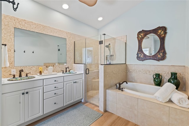 bathroom featuring vanity, separate shower and tub, and hardwood / wood-style floors