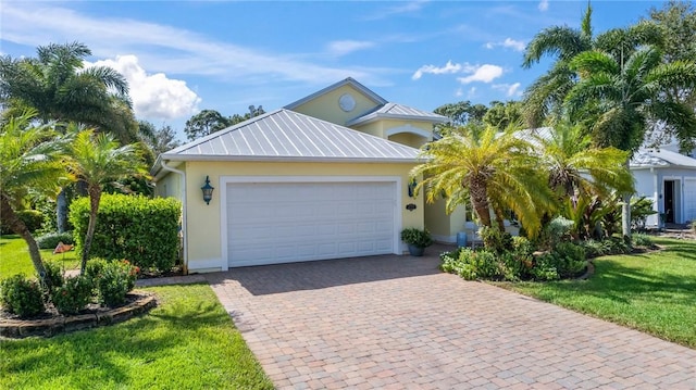 view of front of house with a garage and a front lawn