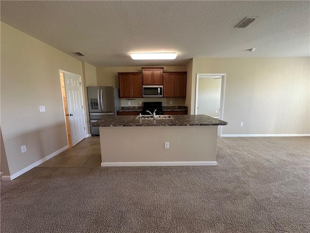 kitchen featuring carpet floors, stainless steel appliances, visible vents, and a sink