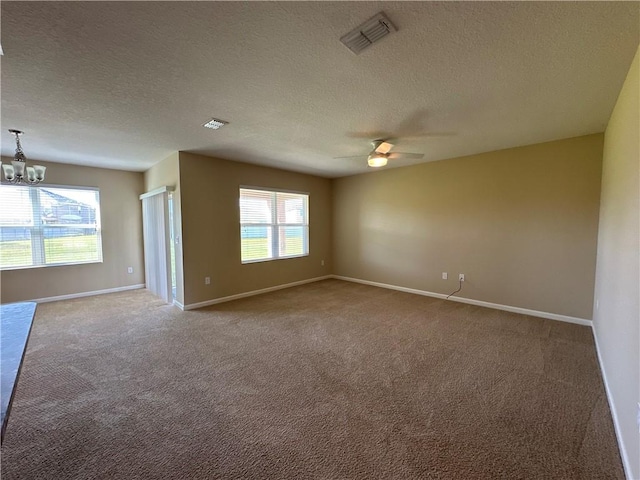 unfurnished room featuring visible vents, a textured ceiling, and carpet floors