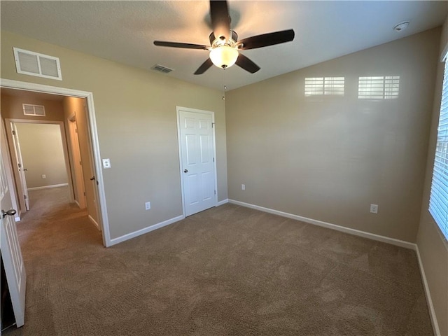 unfurnished bedroom featuring carpet floors and visible vents