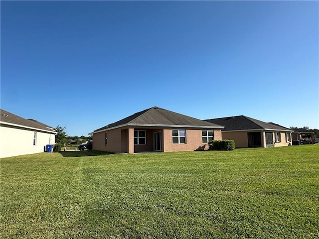 back of property with a lawn