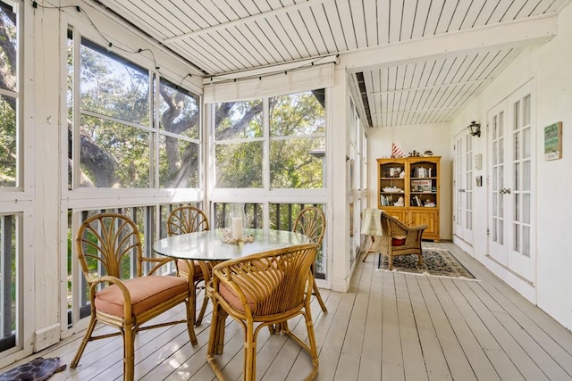 sunroom with plenty of natural light and beam ceiling