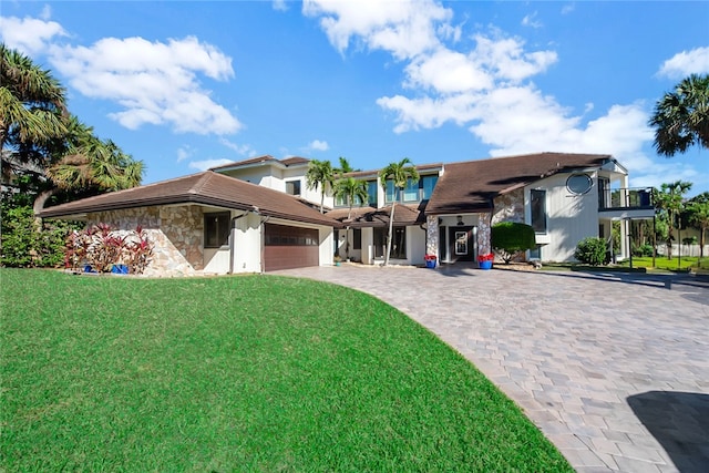 back of house with a yard and a balcony