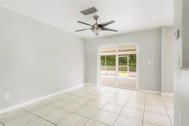 tiled spare room with ceiling fan