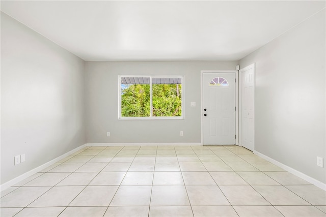 unfurnished room featuring light tile patterned floors