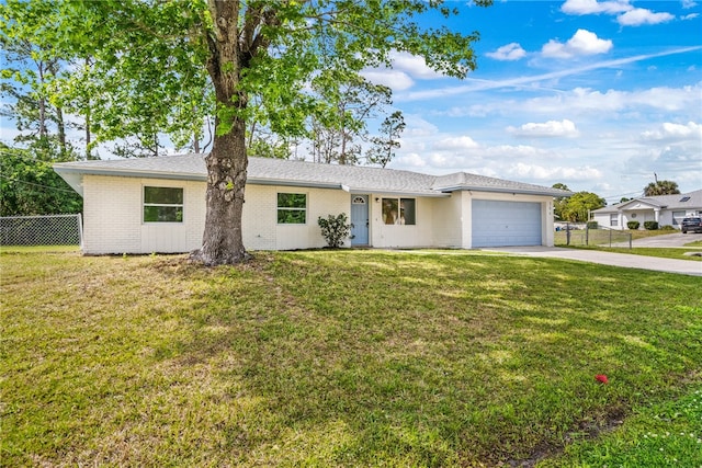 ranch-style home featuring a garage and a front lawn