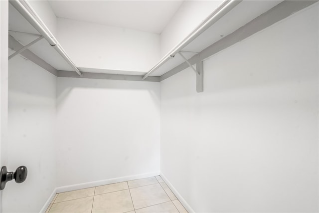 walk in closet featuring light tile patterned flooring