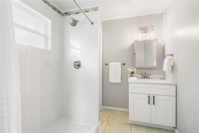 bathroom with vanity, tile patterned floors, and tiled shower