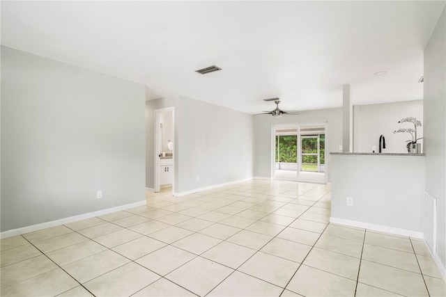 unfurnished room with light tile patterned flooring and ceiling fan