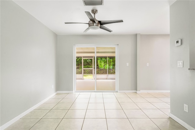 tiled empty room featuring ceiling fan