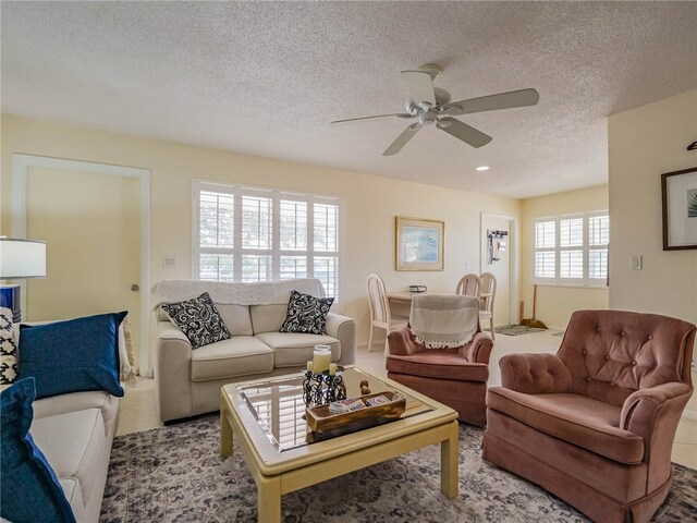 tiled living room featuring ceiling fan and a textured ceiling