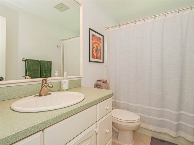 bathroom featuring toilet, vanity, and tile patterned floors