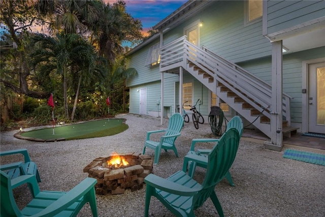 patio terrace at dusk featuring a fire pit