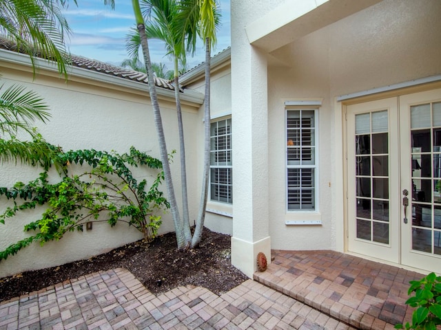 9520 E Maiden Ct, Vero Beach, FL 32963 - doorway to property featuring french doors, stucco siding, and a patio